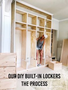 a woman standing on top of a wooden shelf in a room filled with unfinished furniture