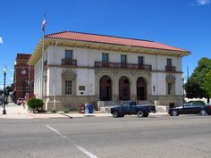 two cars are parked in front of an old building