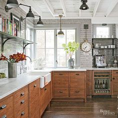 an image of a kitchen with lots of wood cabinets and white appliances on the wall