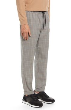 Topped with a comfy elastic waist, these versatile work-to-weekend pants feature a crisp houndstooth-plaid pattern that lends a smart, polished touch. 28 1/2" inseam; 14" leg opening; 11" front rise; 16 1/2" back rise (size Medium) Elastic/drawstring waist 70% polyester, 29% rayon, 1% spandex Machine wash, tumble dry Imported Men's Clothing Glen Plaid, Stretch Pants, Plaid Pattern, Drawstring Waist, Men's Clothing, Elastic Waist, Sweatpants, Nordstrom, Plaid