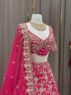 Cerise pink enhanced with pearl, diamonds stone & beads, sequence work highlighted in multi thread floral embroidery flared lehenga. Accomplished with similarly embroidered designer blouse and net dupatta. This pink lehenga is something extraordinary about the blend of ethnic fashion with contemporary details. Fabric: Raw Silk Size: 38/M Occasion: Wedding Ceremony or Reception WASH CARE INSTRUCTIONS - Please Dry clean only when it is applicable. Slight color variation is possible due to digital Pink Dola Silk Gown With Dori Work, Pink Embellished Organza Dupatta, Pink Embroidered Dola Silk Gown, Embellished Pink Organza Anarkali Set, Pink Embellished Organza Anarkali Set, Pink Party Gown With Intricate Embroidery, Designer Pink Embellished Choli, Pink Embellished Organza Lehenga, Pink Embellished Floor-length Lehenga