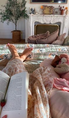 a person laying in bed reading a book