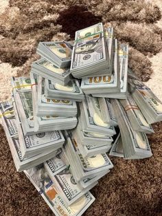 a pile of money sitting on top of a rug