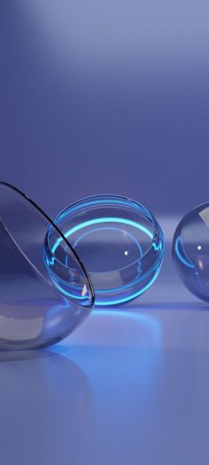 two glass vases sitting next to each other on a table