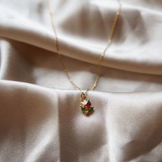 Ultra Dainty Flower Necklace Tulip Necklace Rose Necklace Flower Charm Necklace Beauty and the Beast Inspired Delicate Jewelry Minimalist ☽ 14k Gold plated charm (6.3x7.5mm), red and green cubic zirconia, PLEASE BE AWARE this is a very dainty and delicate necklace (look at pictures to view the size on the model). ☽ This charm is gold plated meaning that it will tarnish over time. PLEASE follow these tips to make the charm last longer in its original condition: avoid wearing it to the beach, pool Dainty Rose Necklace, Ornate Necklace, Dainty Jewelry Necklace, Tulip Necklace, Pretty Jewelry Necklaces, Flower Charm Necklace, Necklace Flower, Jewelry Minimalist, Small Jewelry Box