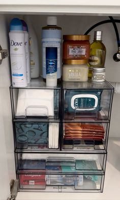 an organized bathroom cabinet filled with toiletries and hygiene products