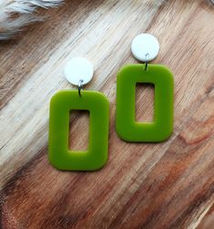 I have hand cast these 1960's mod style earrings in resin, using moss green for the rectangle hoops and  and fixed them to flat white studs.  The hoops measure 30mm x 40mm and the stud tops are 15mm in diameter. The earrings have a total drop of 58mm Lightweight and easy to wear, these colourful geometric earrings will add a burst of colour to any outfit and they will make the perfect gift for lovers of mid century fashion.   You can find more of my 60s inspired geometric earrings here: www.etsy.com/uk/shop/RosieMays?section_id=39023337 Please get in touch if you'd like these in a different colour. Thank you for visiting Handmade Rectangular Retro Jewelry, Retro Green Drop Earrings, Handmade Green Rectangular Jewelry, Handmade Square Green Earrings, Square Green Handmade Earrings, Handmade Green Square Earrings, Rectangular Green Earrings Gift, Green Rectangular Earrings As A Gift, White Studs