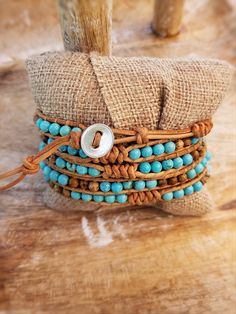 Chic boho wrap bracelet with Bright Turquoise colored beads mixed with Picture Jasper with decorative snake knot accents. Threaded onto natural color raw tan leather. Wraps around the wrist 5 times total. Bracelets are approximately 37 inches in length total and adjustable between 34-36 inches due to several loop closu Bohemian Hand Wrapped Beaded Bracelets On Waxed Cord, Bohemian Hand-strung Bracelets With Waxed Cord, Bohemian Hand-wrapped Waxed Cord Bracelet, Artisan Hand Wrapped Turquoise Wrap Bracelet, Adjustable Hand Wrapped Leather Wrap Bracelet, Artisan Turquoise Hand Wrapped Wrap Bracelet, Hand Wrapped Turquoise Spiritual Wrap Bracelet, Earthy Adjustable Hand Wrapped Bracelet, Adjustable Earthy Hand Wrapped Bracelet