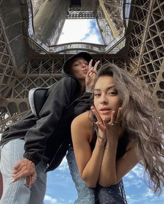 two people standing in front of the eiffel tower