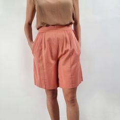 "Beautiful, smart vintage ladies shorts in peach pink. It has a fitted waist with side zip fastening, neat pleats, stitched crease line and side pockets. Perfect for looking smart in the city or worn casualy with a T-shirt. Made by Bhs in Britain. 65% polyester, 35% cotton. Labelled as size 14UK, to fit 97cm/ 38\" hips. Measurements when laid flat are: Waistband: 37cm Hips: 58cm Inner seam: 20cm Outer seam/length: 53cm Excellent condition. B." Fitted Pleated Waist Shorts For Work, Workwear Bottoms With Pleated Waist And Short Length, Pleated Waist Short Bottoms For Workwear, Pleated Waist Short Workwear Bottoms, Pink Shorts With Belt Loops, Casual Workwear Bottoms With Box Pleat, Peach Short Length Bottoms, Fitted Shorts With Pleated Waist, Peach Shorts For Summer