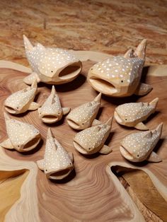 wooden shoes are arranged on a table with polka dotty paper cones and wood spoons