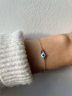 Brush away negative energy and jealous prying eyes with this dainty evil eye bracelet!  D E T A I L S  *It features a stainless steel and enamel evil eye charm. This measures around 20mm. The enamel eye actually has grooves and moves in between the oval link. *It has been wire wrapped to a dainty stainless steel chain. Choose between gold or silver. *Stainless steel does not tarnish or oxidise and is also amazingly hypo allergenic. *It closes with a stainless steel lobster clasp. *Bracelet comes with an explanatory card and is gift ready. S I Z I N G *  H E L P *Choose the length from the drop down menu. Use the length guide as a reference. If unsure what size you need you can choose to ask for an extender to be added in the personalisation section. C A R E * T I P Stainless steel is very Sterling Silver Evil Eye Bracelet With Adjustable Chain, Spiritual Sterling Silver Evil Eye Bracelet, Minimalist Evil Eye Bracelet With Adjustable Chain As Gift, Evil Eye Bracelet For Everyday Wear, Silver Evil Eye Chain Bracelet Gift, Silver Metal Evil Eye Bracelet As Gift, Dainty Silver Evil Eye Bracelet, Minimalist Evil Eye Bracelet With Adjustable Chain, Silver Chain Bracelet With Evil Eye Detail