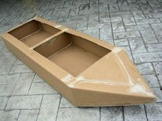 a cardboard boat is sitting on the ground