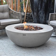 a fire pit sitting on top of a stone patio