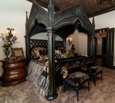 a bedroom with a canopy bed and leather furniture