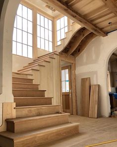 the inside of a house being remodeled with wood floors and stairs leading up to an open door