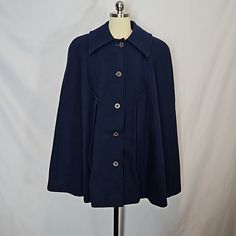 Vintage Pendleton Wool Navy Blue Cape, Estimate Size Is A Small Or Med. Cape Is Lined With A Purple Satin Lining--Lining Is Showing Signs Of Wear With Some Repairs And Some Frayed Areas As Shown, The Top Button Hole Has Some Missing Threads. The Outer Wool Layer Is In Very Nice Condition With No Noted Holes/Flaws. The Cape Is Heavy Weighing About 2.75 Lbs. The Label Is Similar To One Dated From The 70's. No Size Tag, Size Listed Is An Estimate. See Measurements. Measured Flat: Length: 33" Should Classic Blue Peacoat With Button Closure, Classic Blue Peacoat With Buttons, Classic Formal Cape For Fall, Classic Blue Outerwear For Fall, Blue Cape Outerwear For Spring, Blue Fall Cape Outerwear, Blue Cape For Fall, Classic Blue Wool Outerwear, Blue Cape