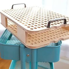 a blue cart with two plastic trays on it