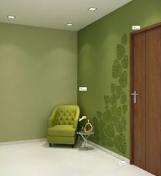 an empty room with a green chair and wooden door