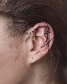 a woman's ear with black lines on it