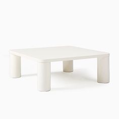 a white coffee table with two legs on the top and one leg raised to the side