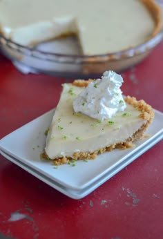 a piece of pie sitting on top of a white plate next to a glass bowl