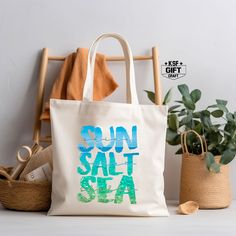 "Sunshine Saltwater Seashells Tote Bag, Summer Gifts For Women, Ocean Vibes Bag, Girls Vacay Bag, Trendy Beach Tote Bag, Gift For Summer Bag Personalized tote bags are perfect for yourself, Your Company, or as a gift! These are also the ideal bride's, Bridal Shower, Baby Shower, Birthday Party, gift, or proposal gift. PRODUCT *Measurements15\"L x 16\"H *12 oz./yd² (US), 20 oz (CA), 100% heavy cotton canvas *20\" canvas webbed handles * 9\" handle drop *Made from Heavy duty cotton canvas fabric *DTF printing for the best color quality * Bulk discounts are available upon request. *Put N/A In the personalization Box For  Blank Tote Bag  Check the Tote bag Color And Text Color Chart In display Pictures Before Order HOW TO ORDER    *Put N/A In the personalization Box For  Blank Tote Bag   *Make Summer Shoulder Bag With Large Capacity, Beige Bags For Beach Season Gift, Large Capacity Summer Shoulder Bag As Gift, Beach Season Gift Tote Shoulder Bag, Summer Gift Shoulder Beach Bag, Summer Beach Shoulder Bag As Gift, Summer Shoulder Beach Bag Gift, Summer Shoulder Beach Bag For Gift, Summer Beach Season Gift Bag