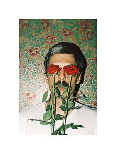 a man with two roses in his mouth