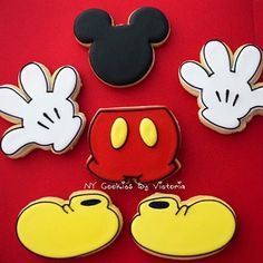 mickey mouse cookies are arranged on a red surface