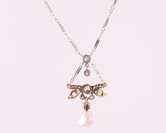 Item Description: This 1870s Victorian Dragonfly motif Necklace features a Natural Free Form Pearl and Old Mine Diamonds in 14 Karat White Gold and Platinum. A Diamond Dragonfly charm drops from the chain and suspends a diamond and pearl charm. The Natural Pearl measures approximately 7.5 millimeters and is Iridescent White with pinks and blues. It has natural rippling and dimpling. This delicate necklace measures 16 inches long and has a safety clasp for extra security. This piece shows that hi Dragonfly Motif, Iridescent White, Dragonfly Charm, Dragonfly Necklace, Natural Pearl, Pearl Charms, Delicate Necklace, Natural Pearls, Antique Victorian