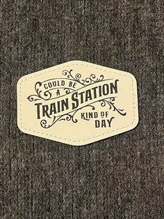 a sticker on the side of a sweater that says, could be a train station kind of day