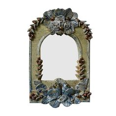 a mirror with flowers and leaves on it