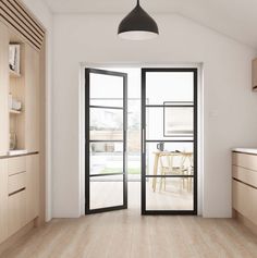 an open door leading to a kitchen and dining room