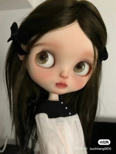 a close up of a doll with big eyes