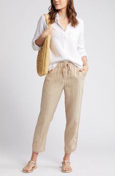 Pull-on pants with a cropped tulip hem are cut from lightweight, cool linen, which makes them ideal for sun-chasing adventures or kicked-back weekends at home. 26" inseam; 12" leg opening; 11" front rise; 16" back rise (size Medium) 24 1/2" petite inseam; 12" leg opening; 10 1/2" front rise; 15" back rise (size Medium P) Drawstring waist Front slant pockets 100% linen Machine wash, line dry Imported Casual Linen Bottoms In Natural Color, Casual Natural Linen Bottoms, Casual Flax Pants For Spring, Casual Flax Tapered Leg Pants, Spring Vacation Tapered Leg Bottoms, Casual Flax Linen Pants, Casual Flax-colored Bottoms For Vacation, Flax Colored Loungewear Bottoms For Spring, Casual Flax Colored Bottoms For Vacation