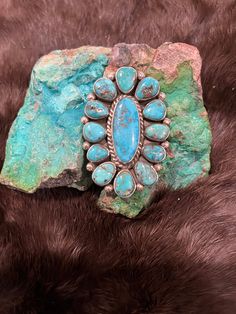 SIGNED Native American Indian Ring Handcrafted of Sterling Silver, Extremely Sought After RARE Nevada Turquoise. Decorated by beautiful silverwork.  Hallmarked by Navajo Artist Aaron Tallis ❤️ Stamped Sterling  Fully Adjustable Fits any size finger Definitely a show stopper! Statement Ring  2 3/8" length 1 5/8"  wide Turquoise, or "Doo tl' izh ii" in Navajo, holds a very special significance in several Native American cultures, especially for the Navajo people. This semi-precious gemstone that i Southwestern Turquoise Concho Ring As A Gift, Southwestern Style Turquoise Concho Ring As Gift, Southwestern Concho Ring Jewelry, Southwestern Turquoise Ring With Concho, Southwestern Turquoise Ring, Indian Ring, Navajo Turquoise Jewelry, Indian Rings, Turquoise Statement Ring