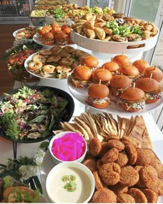 an assortment of food is displayed on a buffet table