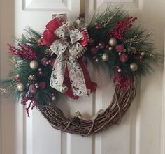 a christmas wreath hanging on the front door