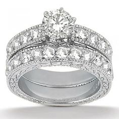 a white gold diamond ring set with matching wedding bands and an engagement ring on top