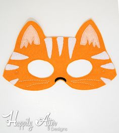 an orange cat mask with white stripes on it