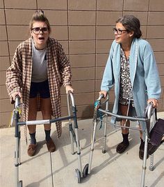 two women with walkers standing next to each other