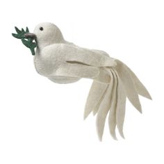 a white bird flying through the air with its wings spread