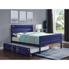 a blue bed with two drawers underneath it