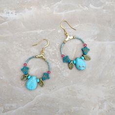 These beaded floral hoop earrings have a lovely mix of flowers, leaves, and large teardrop beads. With 18k gold-plated ear wires. Blue Teardrop Bohemian Flower Earrings, Bohemian Blue Teardrop Flower Earrings, Blue Bohemian Teardrop Flower Earrings, Bohemian Turquoise Flower Earrings Nickel Free, Bohemian Wire Wrapped Flower Earrings, White Howlite Jewelry, Celtic Knot Bracelet, Howlite Jewelry, Earrings Handmade Boho