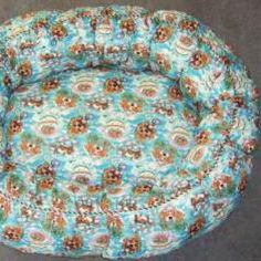 a round dog bed with flowers on it