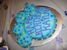 a birthday cake with blue frosting and polka dots