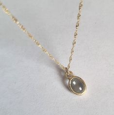 "Beautiful solid gold pendant necklace with an oval blue topaz, minimalist jewelry for women in 9k or 14k solid yellow gold. This regal necklace is solid gold and has an oval solid gold pendant. The pendant is set with an oval blue topaz with a light blue color.  It is available in 9k or 14k solid yellow gold in 16\" or 18\" lengths. This necklace is simply breathtaking. It is delicate and romantic yet striking and meaningful. You can wear it as a single item or layered with other necklaces for a total boho-chic look. It will accompany you for many years to come. Don't hesitate to order this fabulous necklace and enrich your look with this romantic piece. Item details: 1 solid gold pendant necklace. Dimensions: Pendant size: 0.4\"x0.3\" (9.5mmX7.5mm). Gemstone size: 0.23\"x0.31\" (6mmX8mm) Regal Necklace, Oval Pendant Necklace, Romantic Jewelry, Blue Topaz Necklace, Romantic Jewellery, Solid Gold Necklace, Topaz Necklace, Dainty Gold Necklace, Personalized Pendant