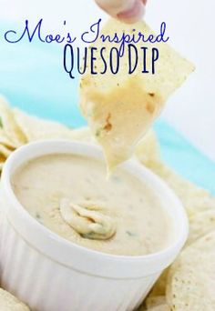 a person dipping tortilla chips into a white bowl filled with quesadilla dip