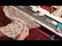 someone is working on something that looks like an old weaving machine with yarn in it