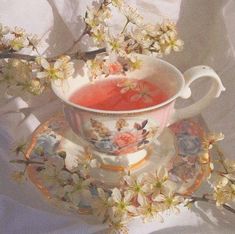 a tea cup and saucer with flowers on it